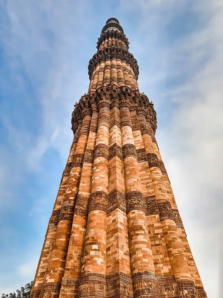 Looking up at the carved sandstone Qutub Minar in Delhi