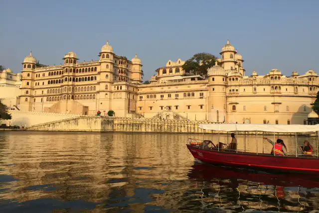 City Palace on Lake Pichola in Udaipur, with a boat on the water
