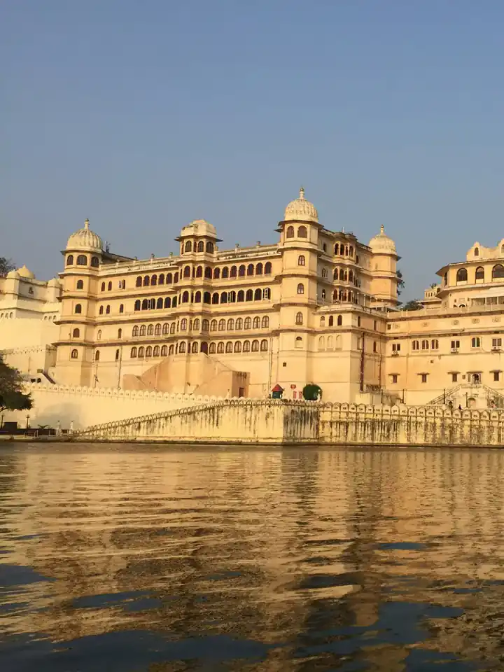 City Palace on Lake Pichola in Udaipur, with a boat on the water